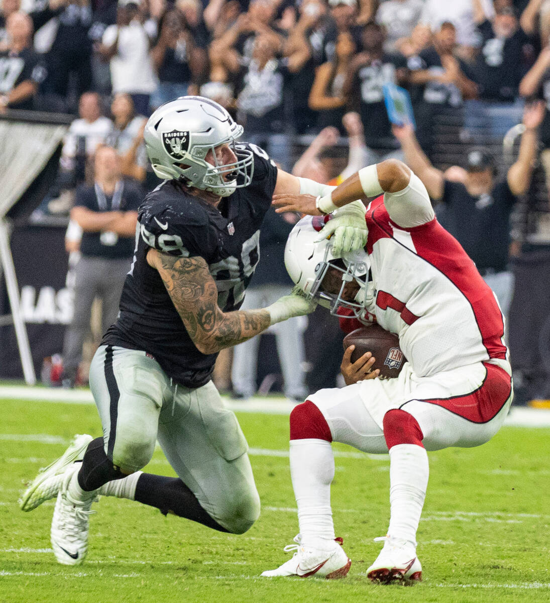 Arizona Cardinals quarterback Kyler Murray (1) avoids a tackle from Raiders defensive end Maxx ...