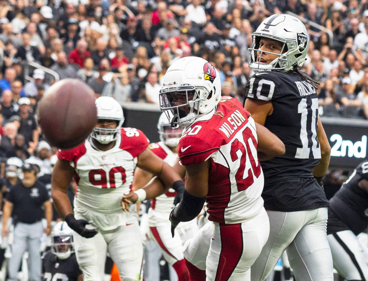 Arizona Cardinals cornerback Marco Wilson (20) and Raiders wide receiver Mack Hollins (10) watc ...