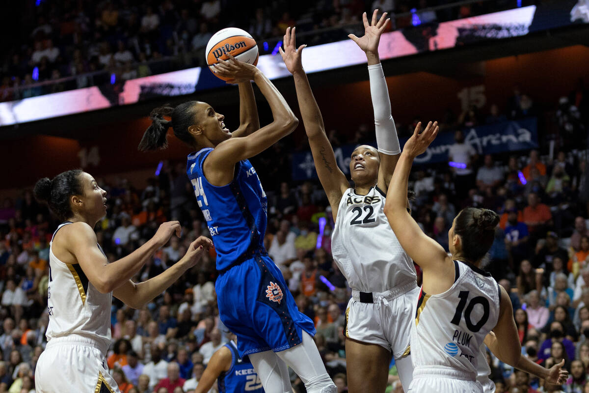 Connecticut Sun forward DeWanna Bonner (24) shoots while Las Vegas Aces forward A'ja Wilson (22 ...