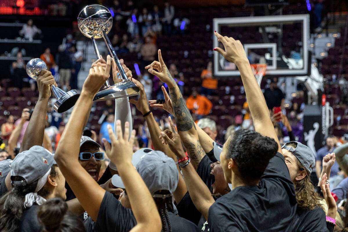 The Las Vegas Aces cheer with their new 2022 WNBA Championship trophy after winning Game 4 of a ...