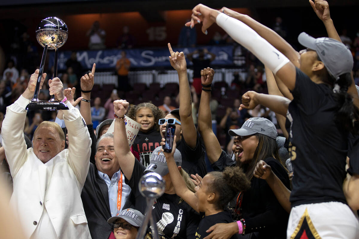 The Las Vegas Aces go wild as owner Mark Davis holds up the 2022 WNBA Championship trophy after ...