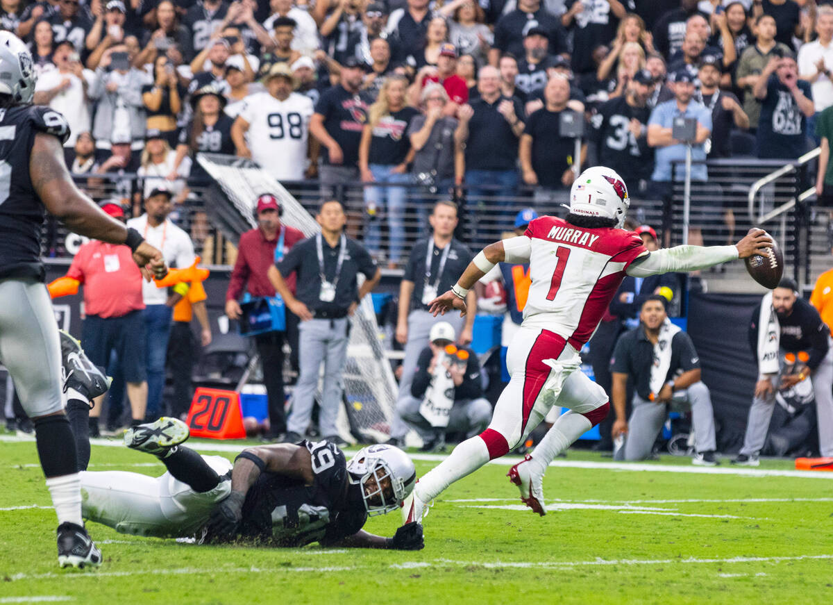 Arizona Cardinals quarterback Kyler Murray (1) avoids a tackle from Raiders defensive end Maxx ...