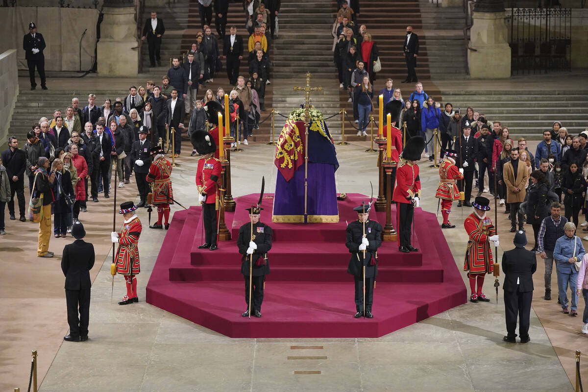 The final members of the public pay their respects at the coffin of Queen Elizabeth II, draped ...