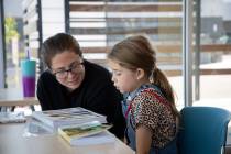 Leanne Pinault helps her daughter Presley, 8, with vocabulary lessons in the new West Henderson ...