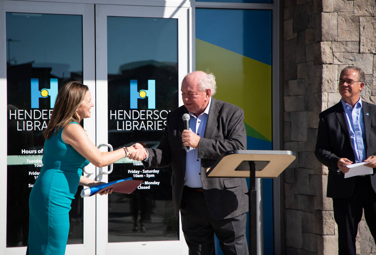 Councilman Dan Shaw shakes hands with Marcie Smedley, Henderson Libraries executive director, a ...