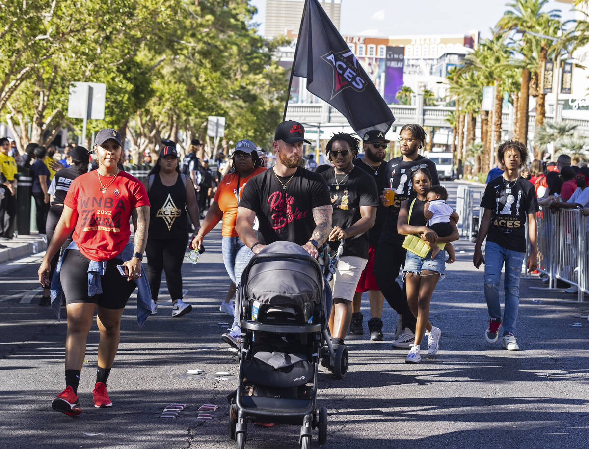 Fans walk along Las Vegas Boulevard to attend the Las Vegas Aces WNBA Championship victory para ...