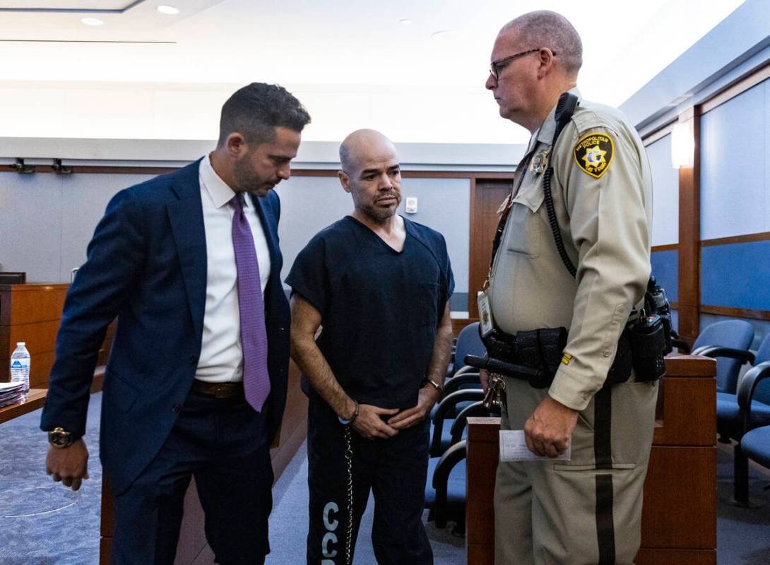 Outgoing Clark County Public Administrator Robert Telles, center, leaves the courtroom with Dav ...