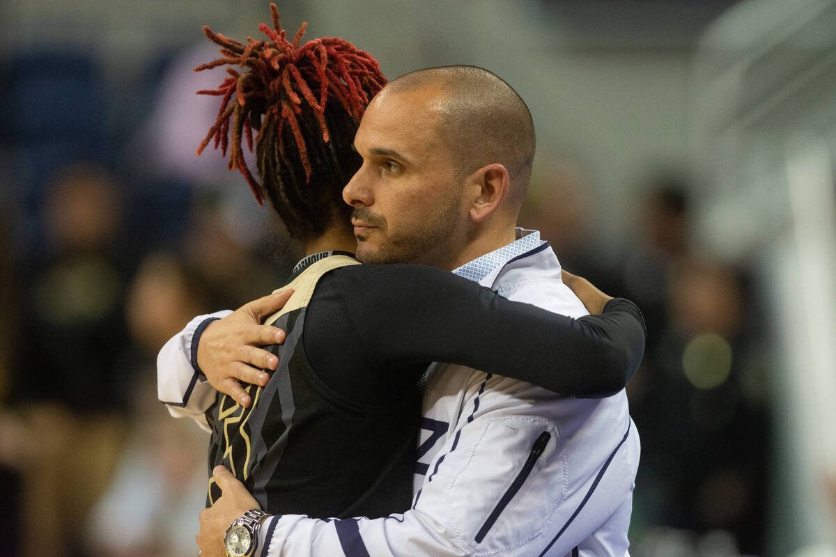 Spring Valley High School coach William Hemberger hughs senior Aaliyah Gayles following their l ...