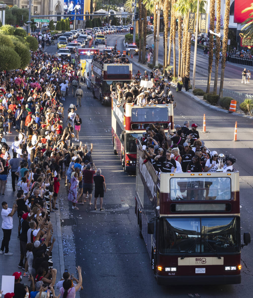 Fans watch as the Las Vegas Aces pass by during the team's WNBA Championship victory parade on ...