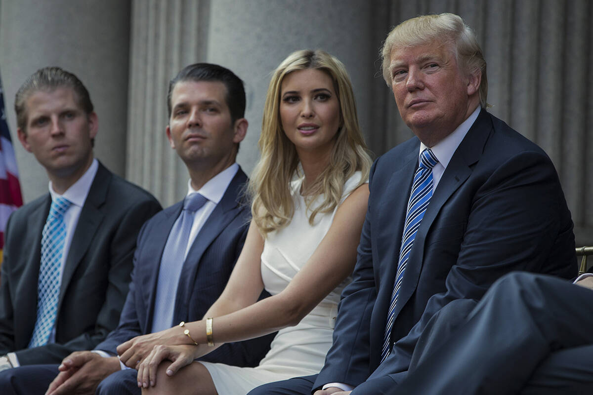 FILE - Donald Trump, right, sits with his children, from left, Eric Trump, Donald Trump Jr., an ...