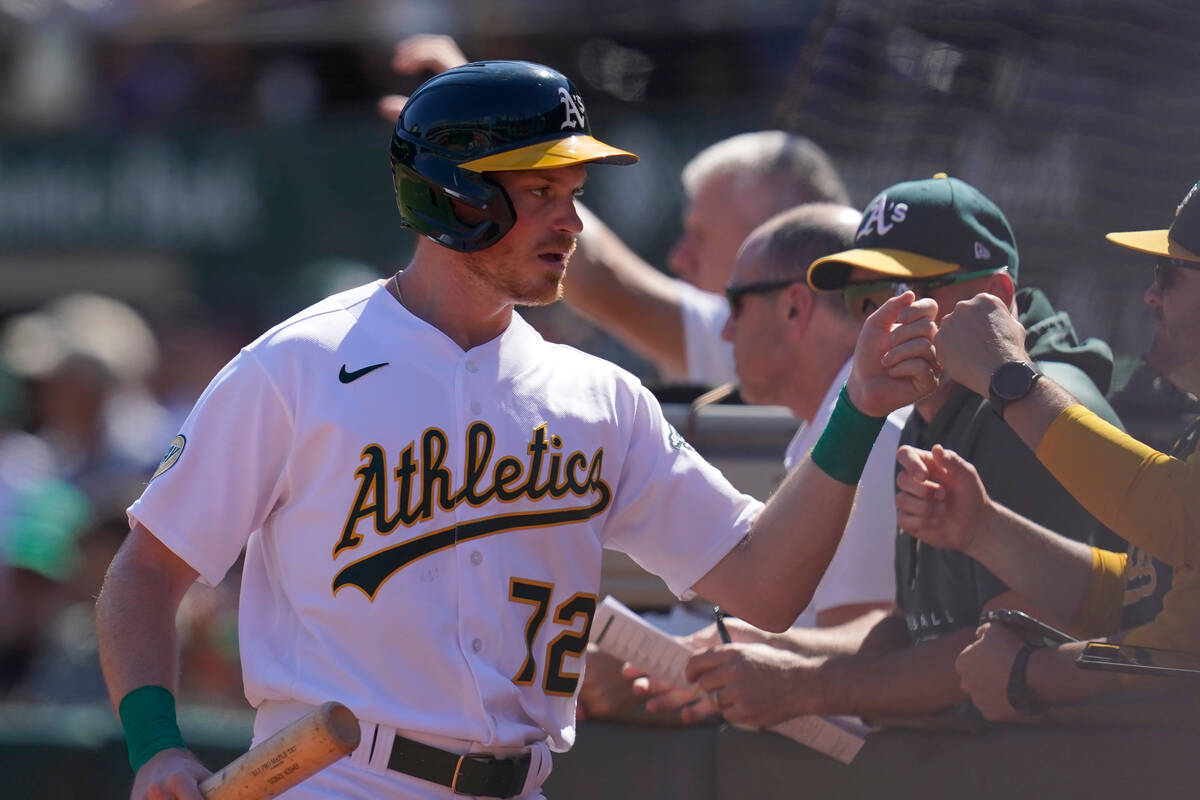 Oakland Athletics' Conner Capel is congratulated by teammates after scoring against the Seattle ...