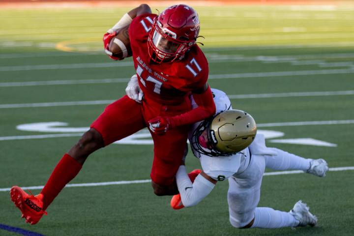 Snow Canyon's Makaio Swensen (5) tackles Arbor View's Amari Derby (17) during the first game of ...