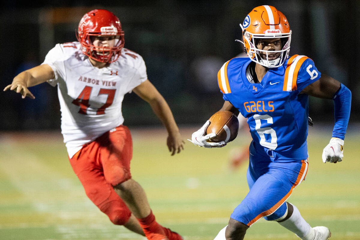 Bishop Gorman's Jonathan Brady (6) returns a punt under pressure from Arbor View's Bryce Ericso ...