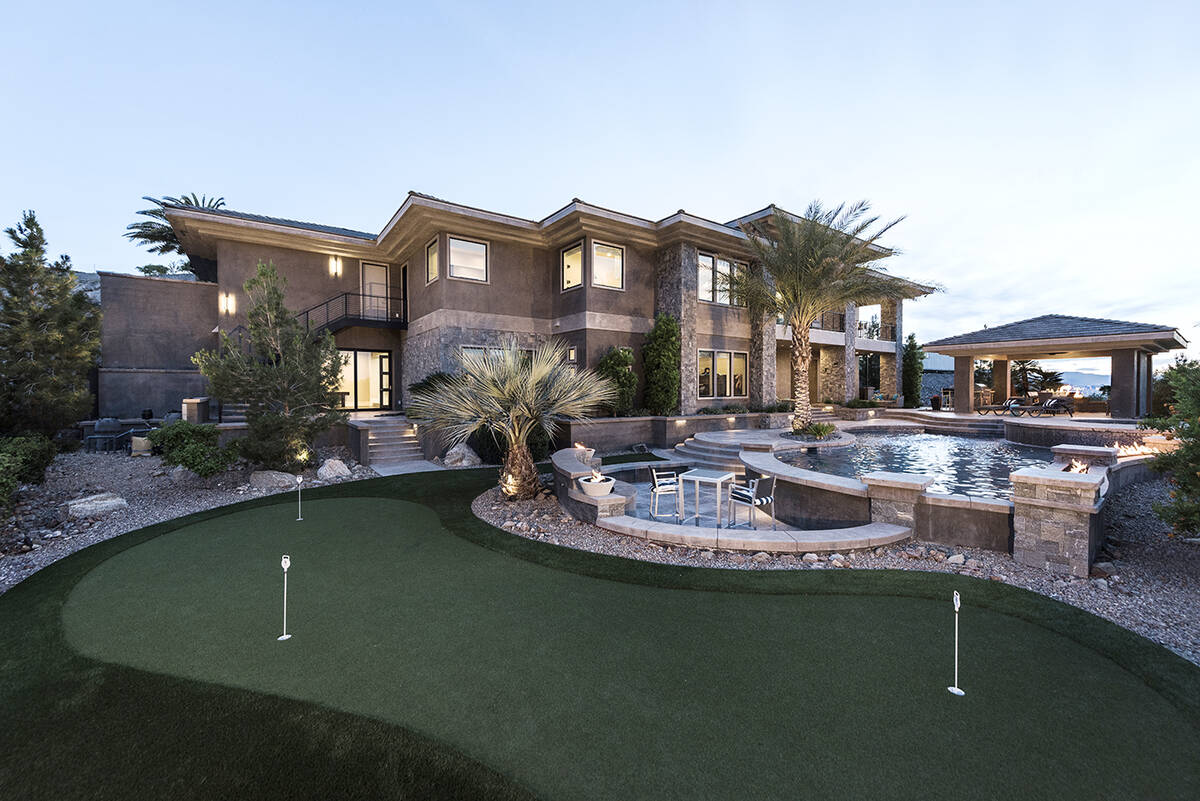 The elevated yard features a putting green. (Rob Jensen Co.)