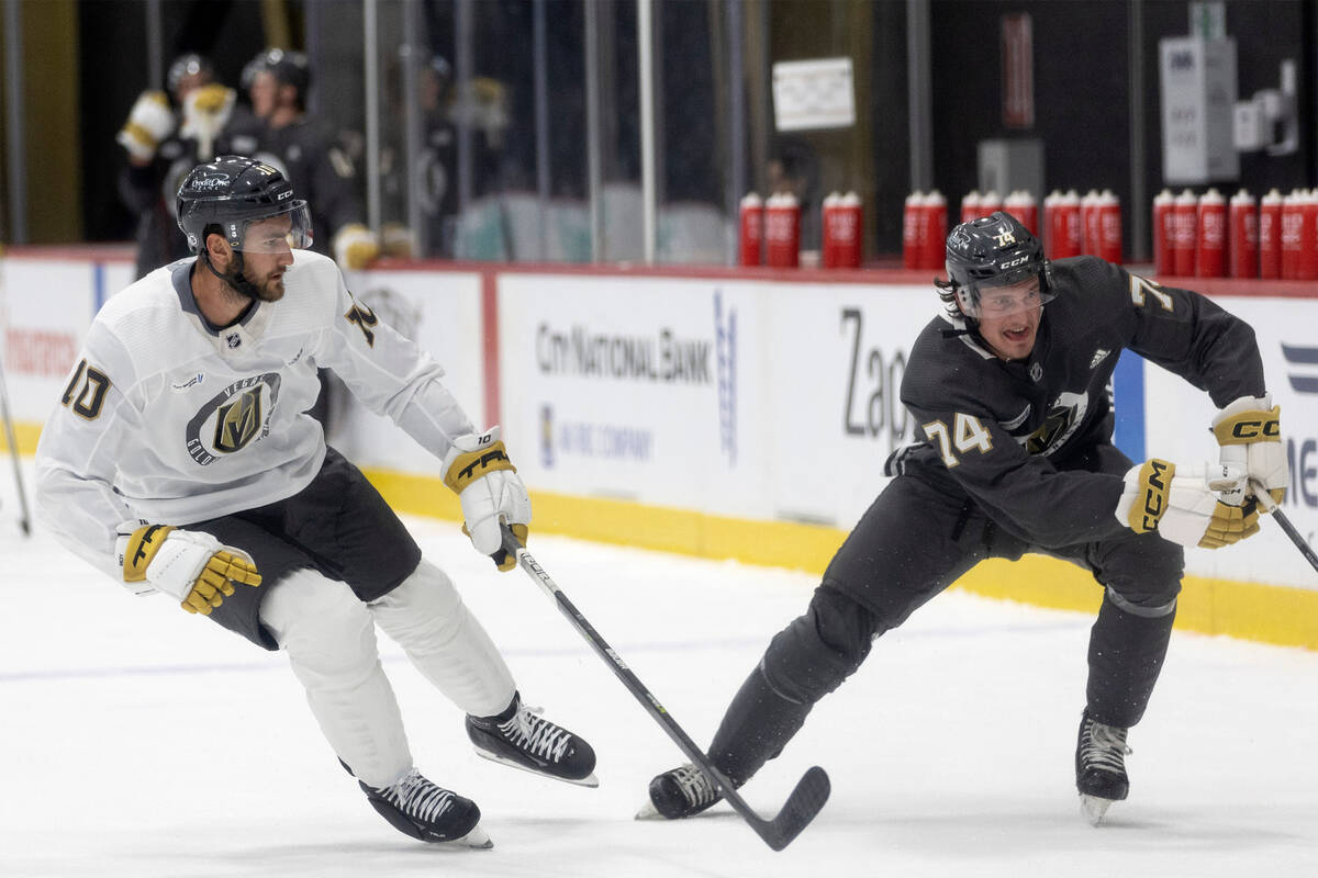 Golden Knights forward Lynden McCallum (74) skates for the puck while forward Nicolas Roy (10) ...