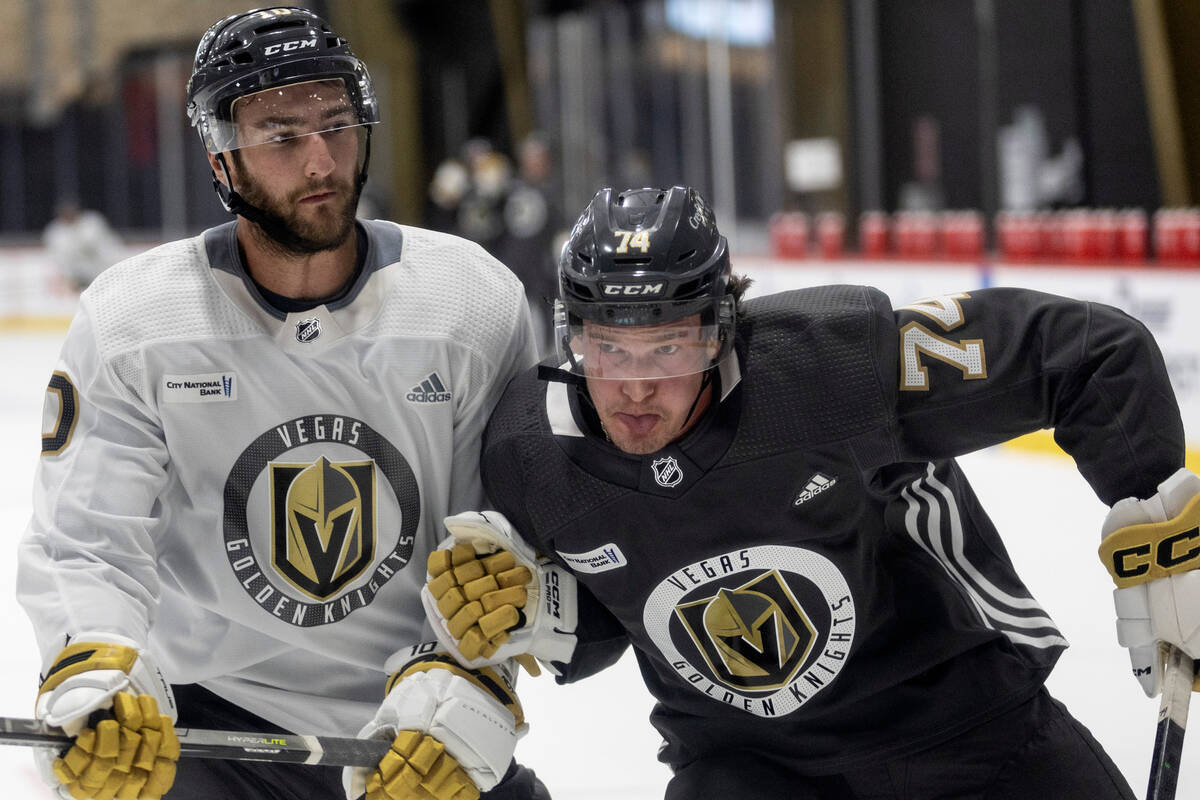 Golden Knights forward Lynden McCallum (74) and forward Nicolas Roy (10) collide during trainin ...