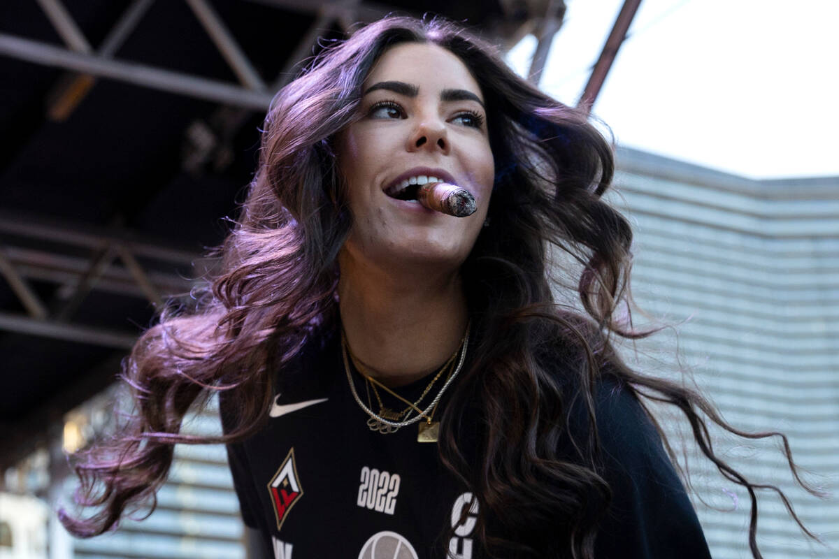 Las Vegas Aces guard Kelsey Plum (10) takes the stage to make a speech during a parade to honor ...