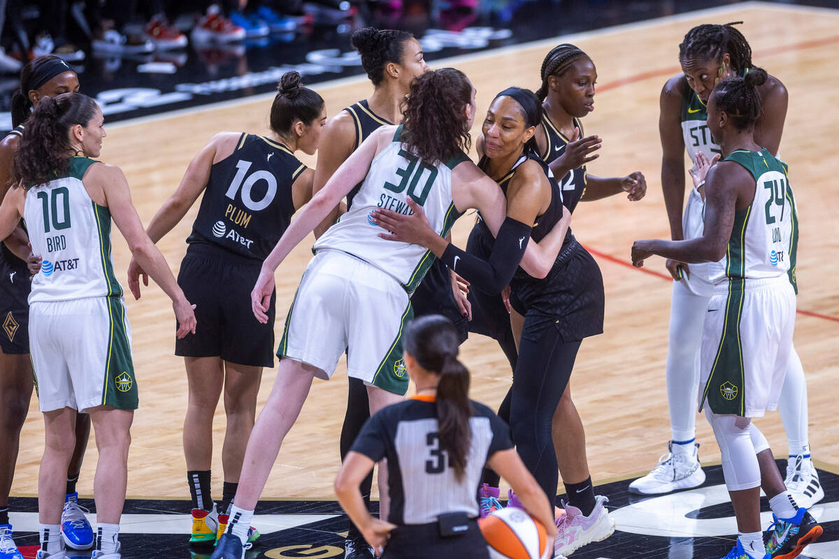 Las Vegas Aces and Seattle Storm players greet each other on the court before the first half of ...