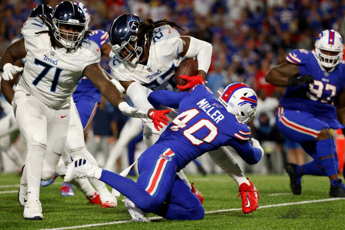 Tennessee Titans running back Derrick Henry (22) is tackled by Buffalo Bills linebacker Von Mil ...