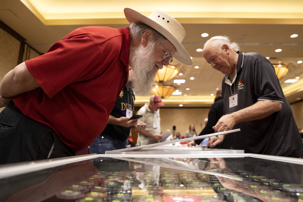 Mark Hall-Patton, retired Clark County Museum administrator, left, looks at poker chips for sal ...