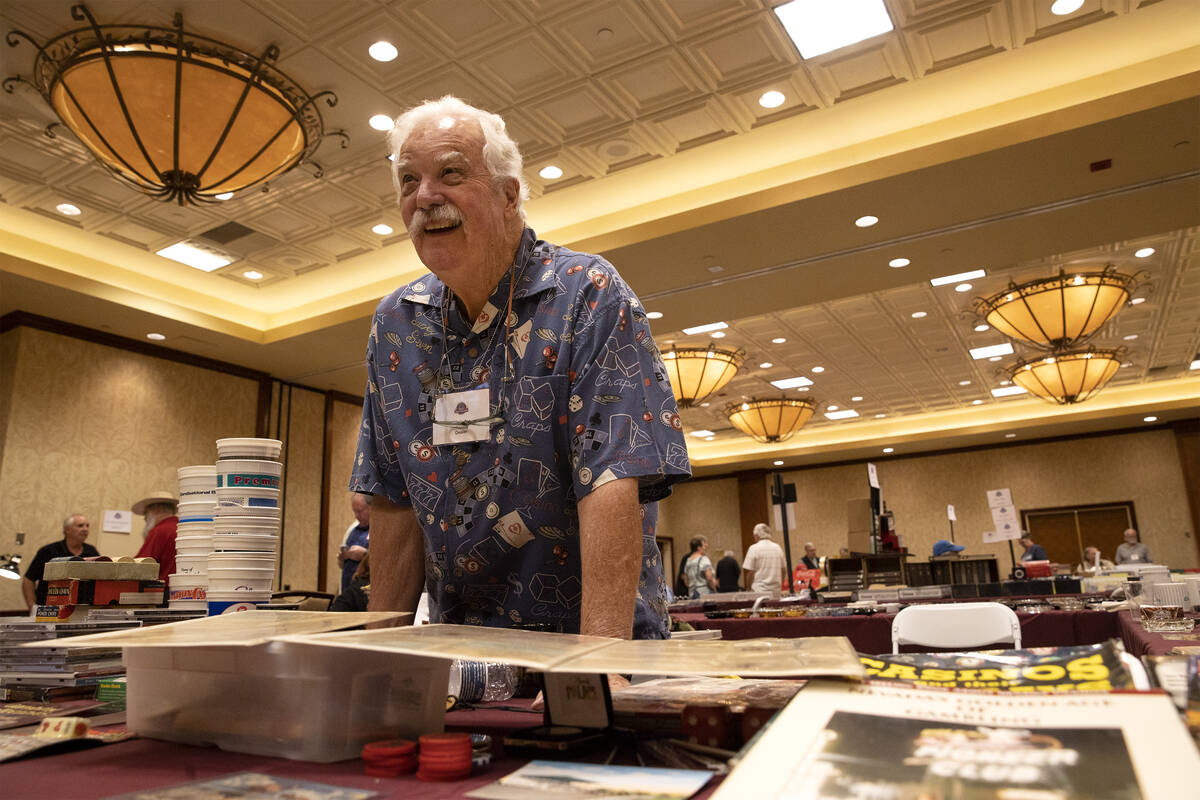 Bill Judge shows a booklet of vintage member cards from illegal casinos during a memorabilia sh ...