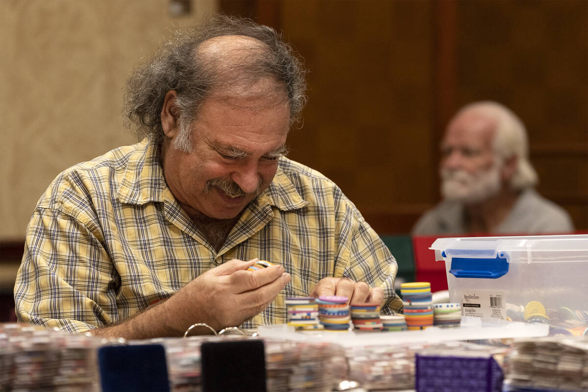 J. Eric Freedner, who travelled from Sun Valley, California, smiles while sifting through poker ...