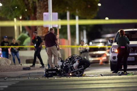 Las Vegas police investigate the scene of an accident involving a police motorcycle officer at ...