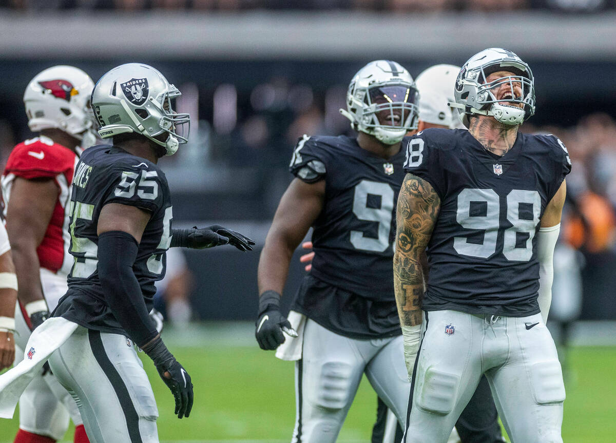 Raiders defensive end Maxx Crosby (98) celebrates a sack with teammates during the first half o ...
