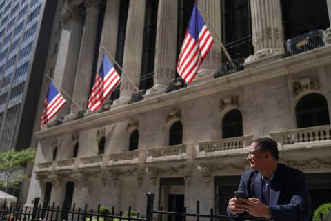 A trader stands outside the New York Stock Exchange, Friday, Sept. 23, 2022, in New York. Stock ...