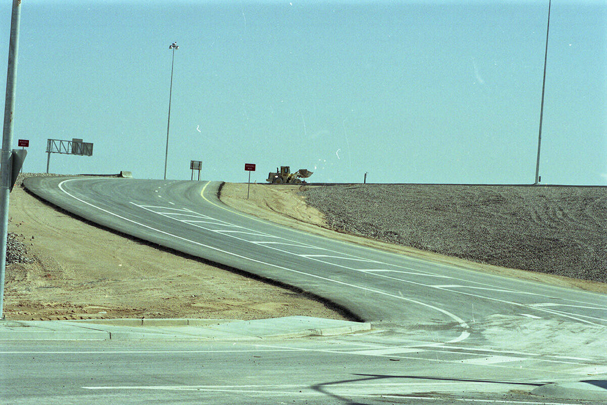 Crews installing traffic lights and road signs near Decatur Boulevard and the newest segment of ...