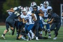 Liberty quarterback Colin Gregorio (4) breaks into the open for a long run versus the Faith Lut ...