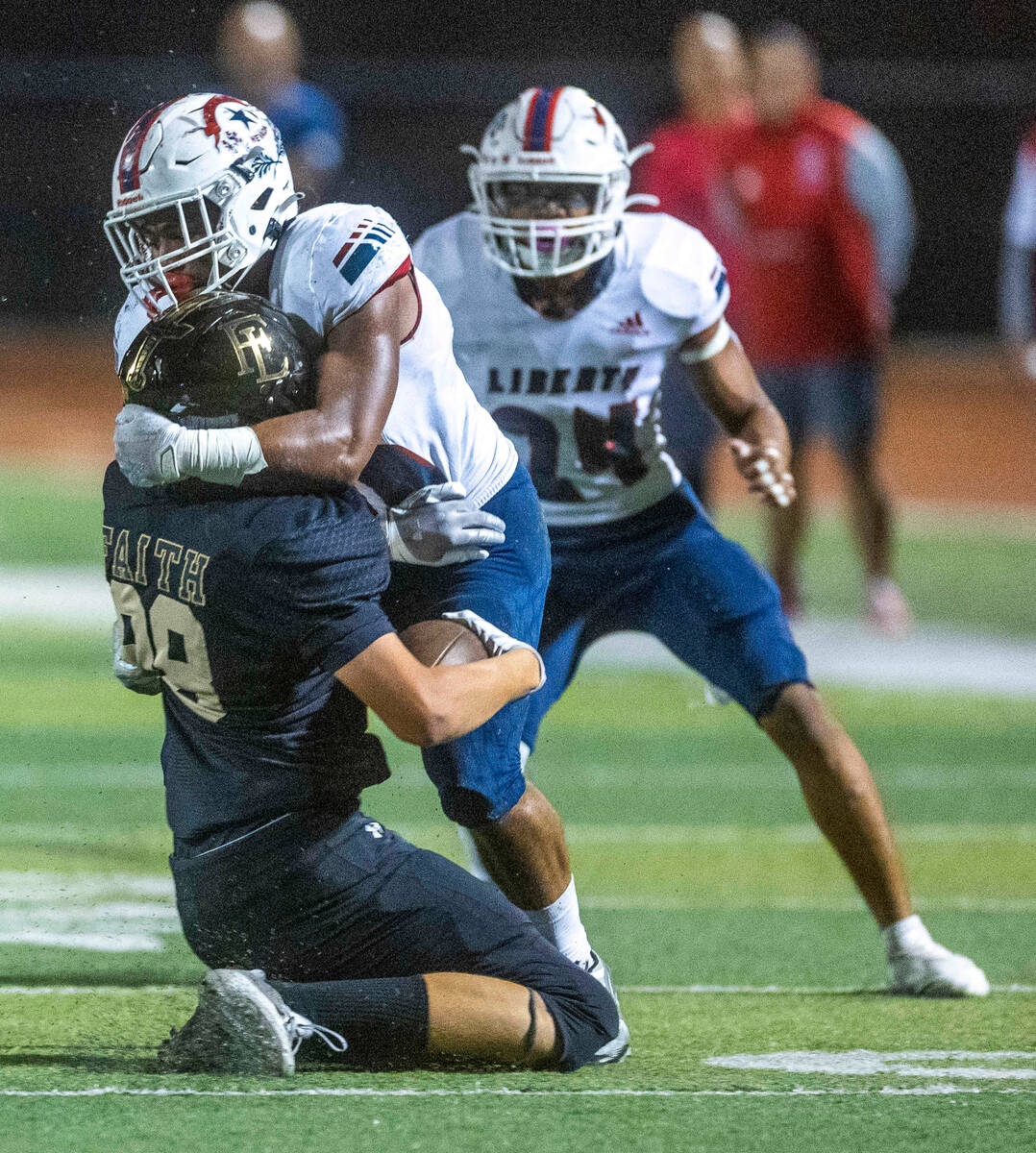 Liberty linebacker Sonny Vitale (10) takes down Faith Lutheran's tight end Cade Keith (88) afte ...