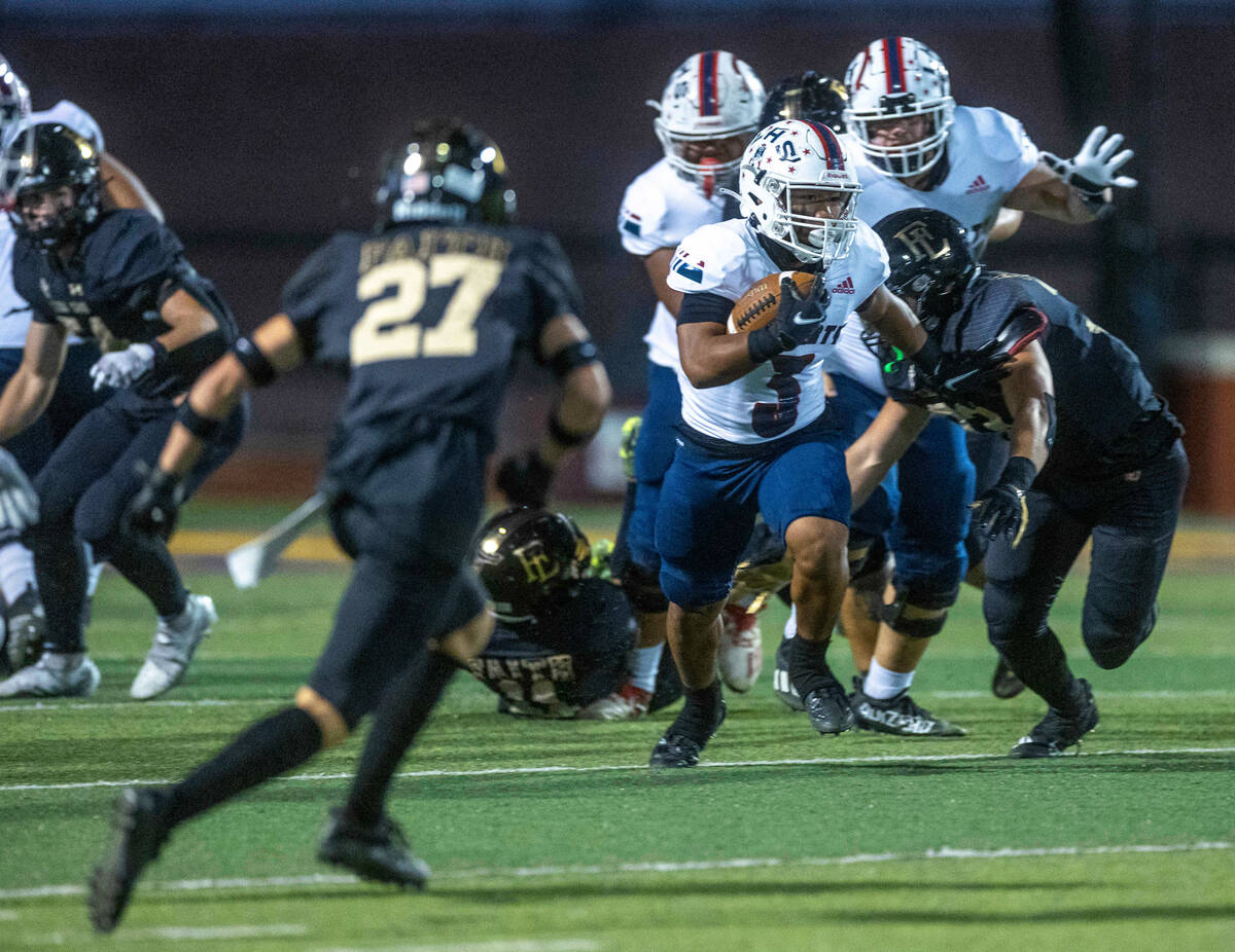 Liberty's running back Isaiah Lauofo (3) breaks free on the Faith Lutheran defense during the f ...