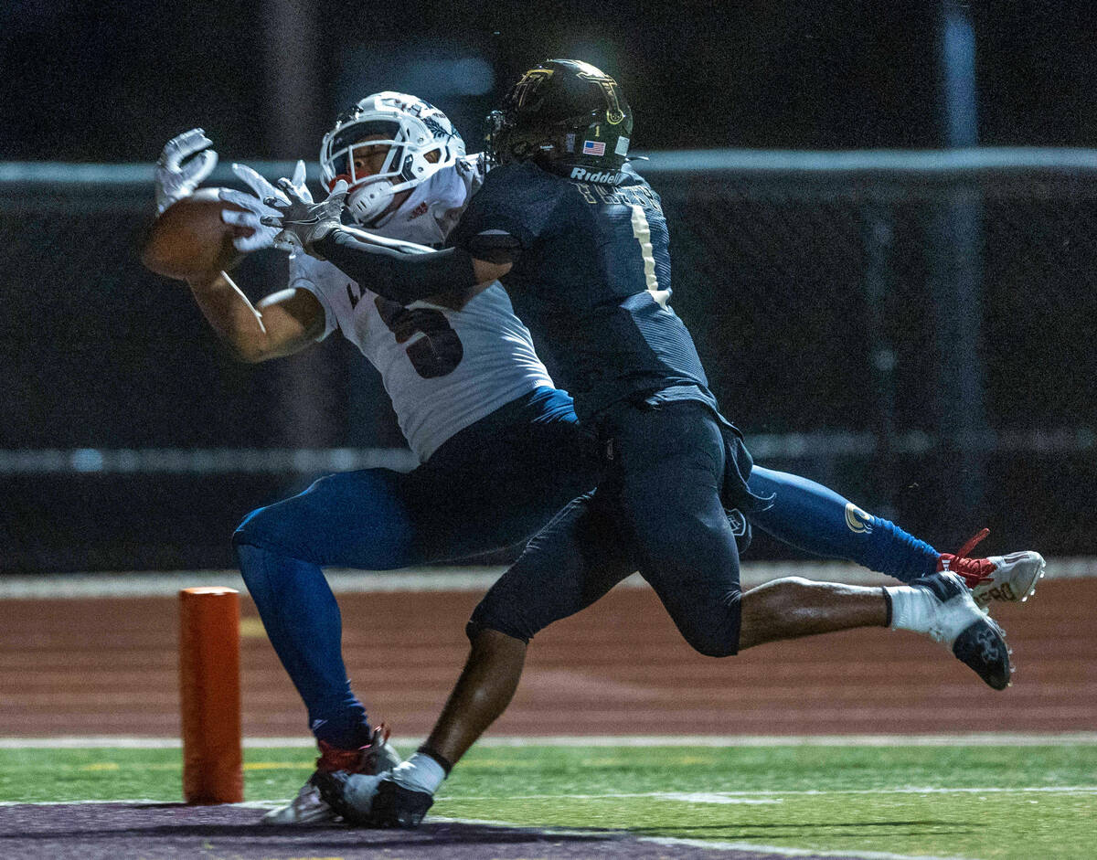 Liberty wide receiver Landon Bell (5) catches a touchdown pass in his fingertips over Faith Lut ...