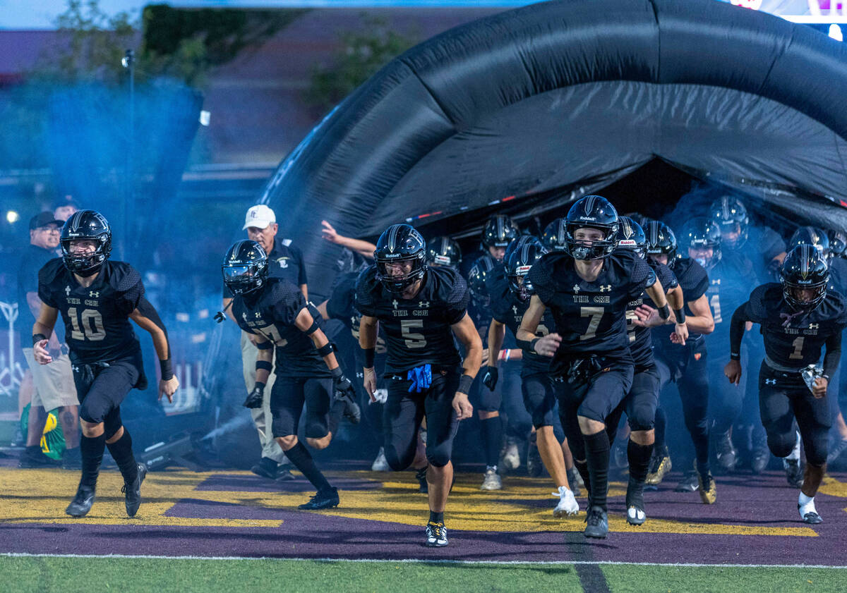 Faith Lutheran players take the field versus Liberty for the first half of their NIAA football ...