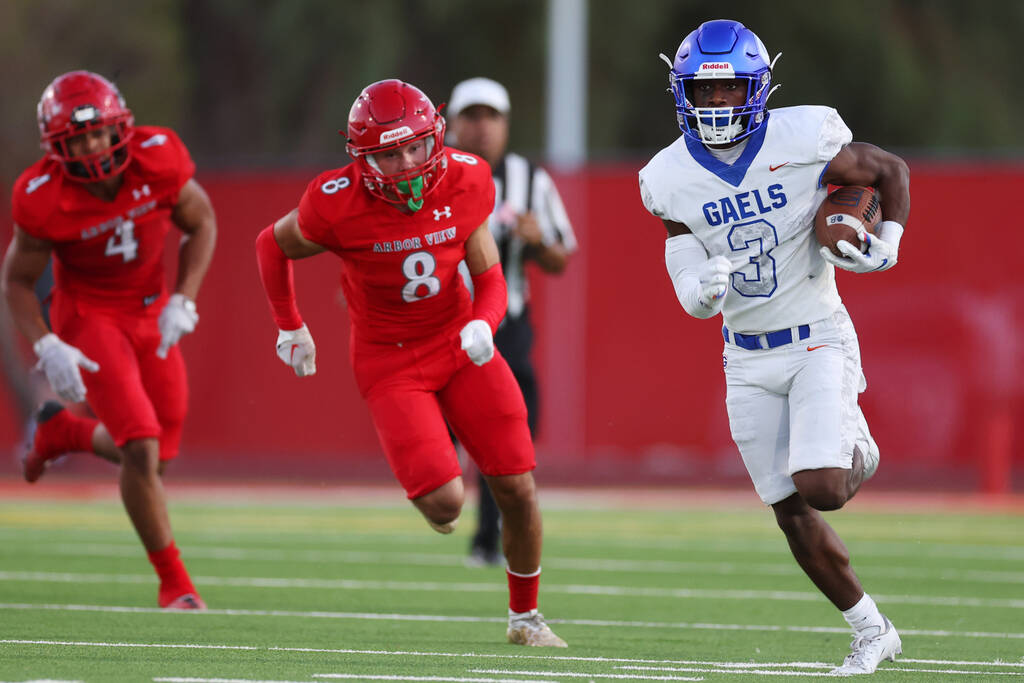 Bishop Gorman's Devon Rice (3) runs the ball under pressure from Arbor View's Kade DeSantis (8) ...