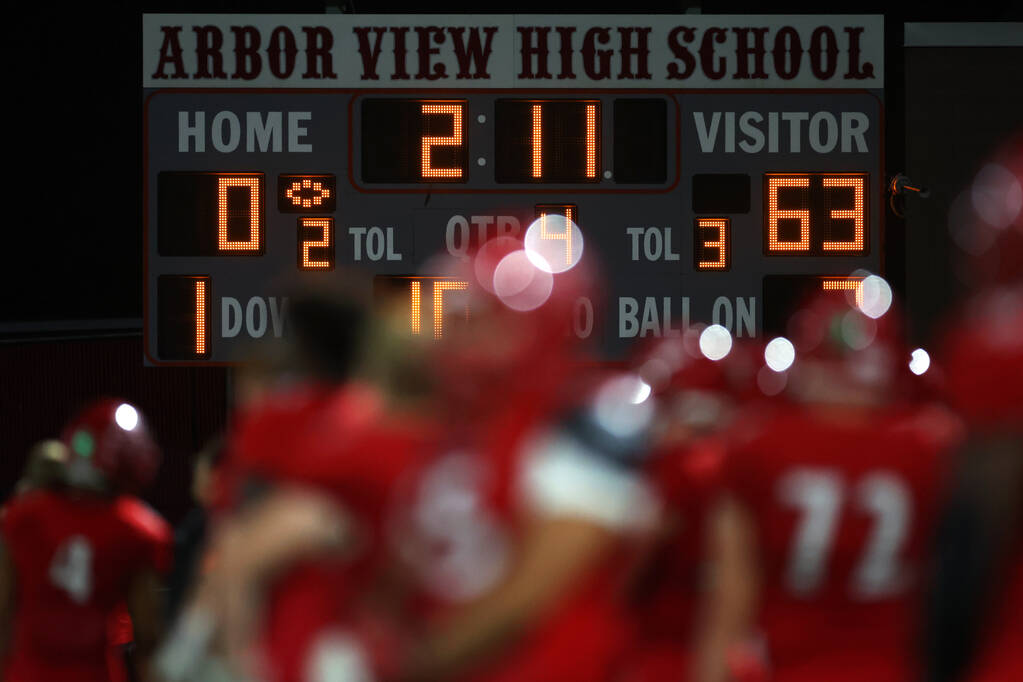 The scoreboard shows Bishop Gorman winning in the second half of a football game against Arbor ...