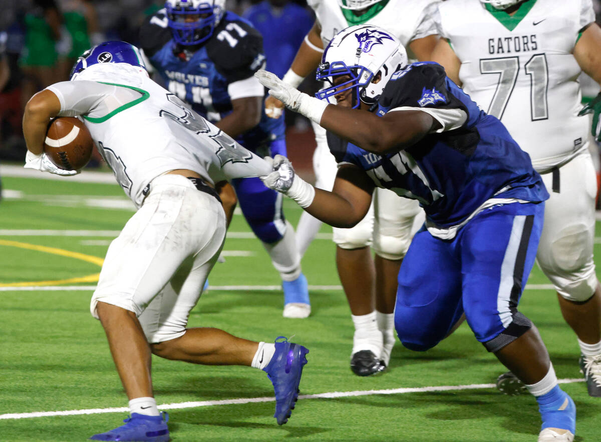 Green Valley High's running back Estaban Martinez (34) avoids a suck from Basic High's Antoine ...