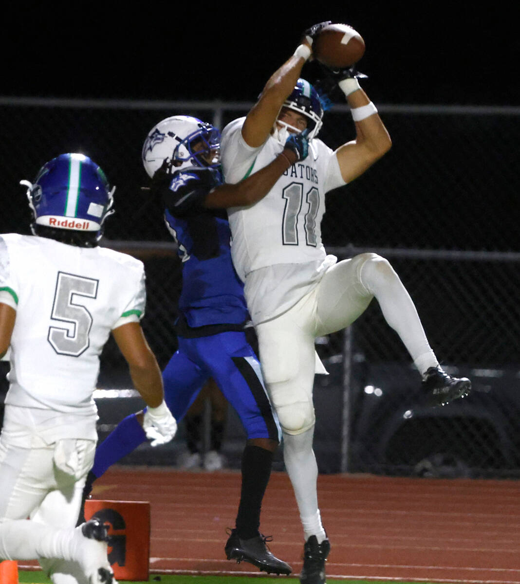 Green Valley High's wide receiver Nate Richter (11) catches a touchdown pass as Basic High's Av ...