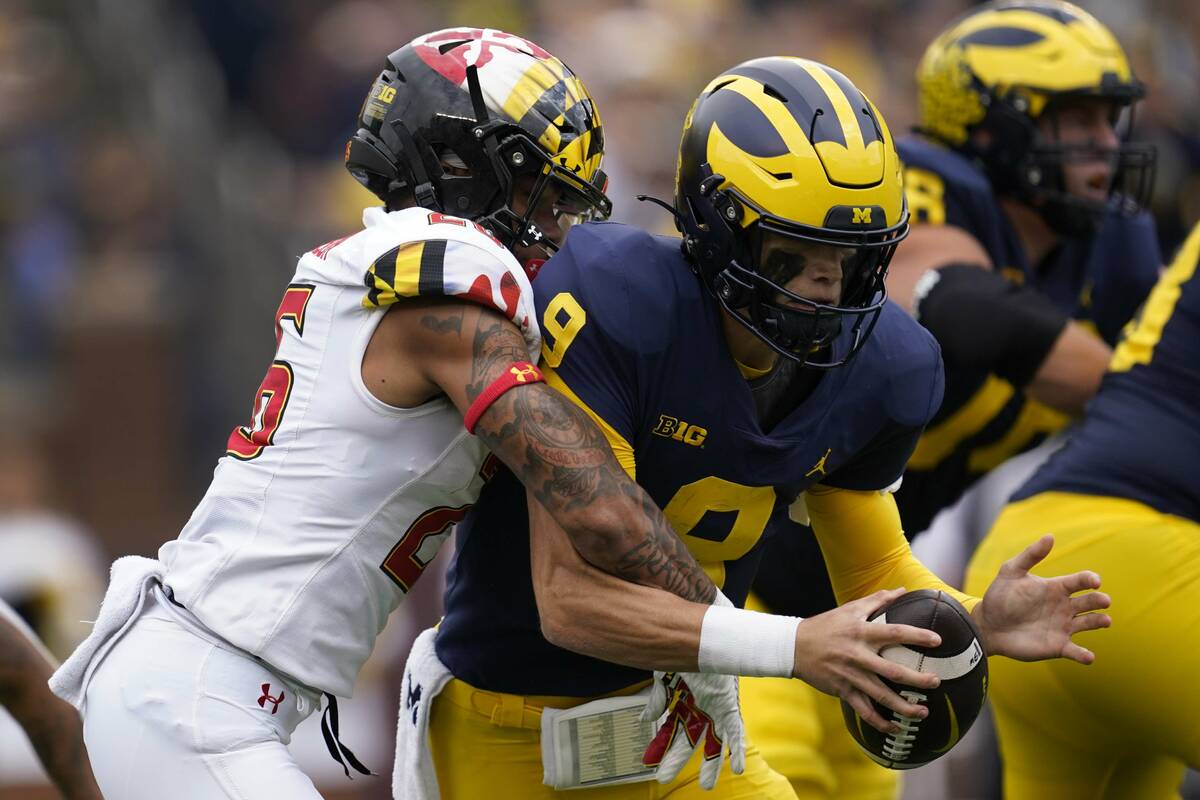 Maryland defensive back Gavin Gibson (26) sacks Michigan quarterback J.J. McCarthy (9) in the s ...