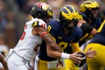 Maryland defensive back Gavin Gibson (26) sacks Michigan quarterback J.J. McCarthy (9) in the s ...