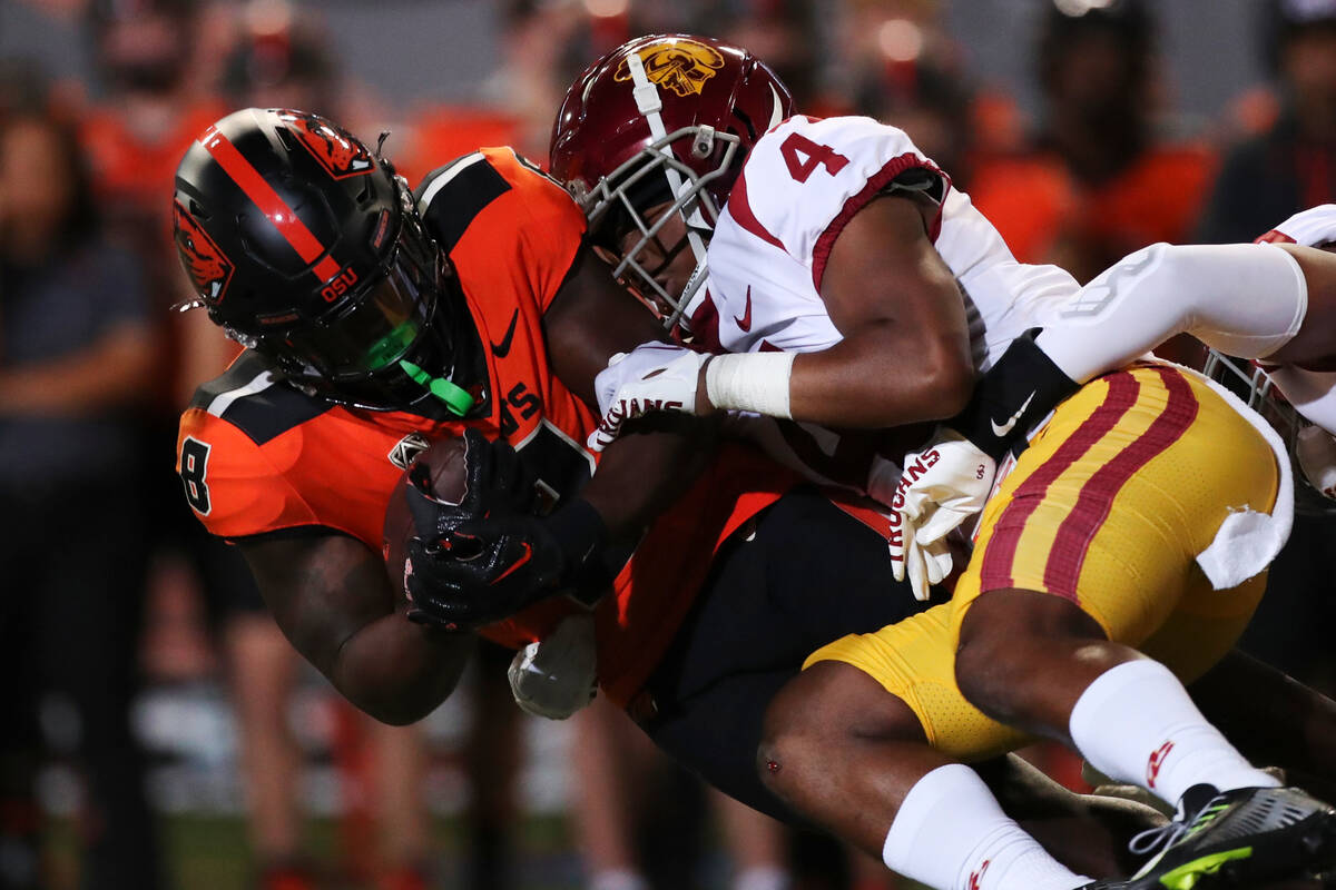 Oregon State running back Jam Griffin is brought down by Southern California defensive back Max ...