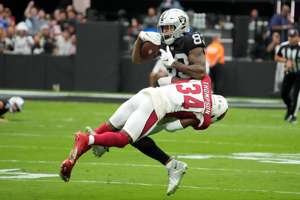 Arizona Cardinals safety Jalen Thompson (34) hits Raiders tight end Darren Waller (83) during t ...