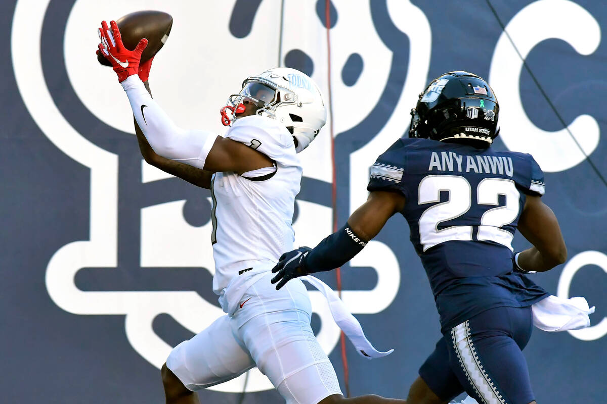 UNLV wide receiver Kyle Williams (1) catches a touchdown pass as Utah State cornerback Michael ...