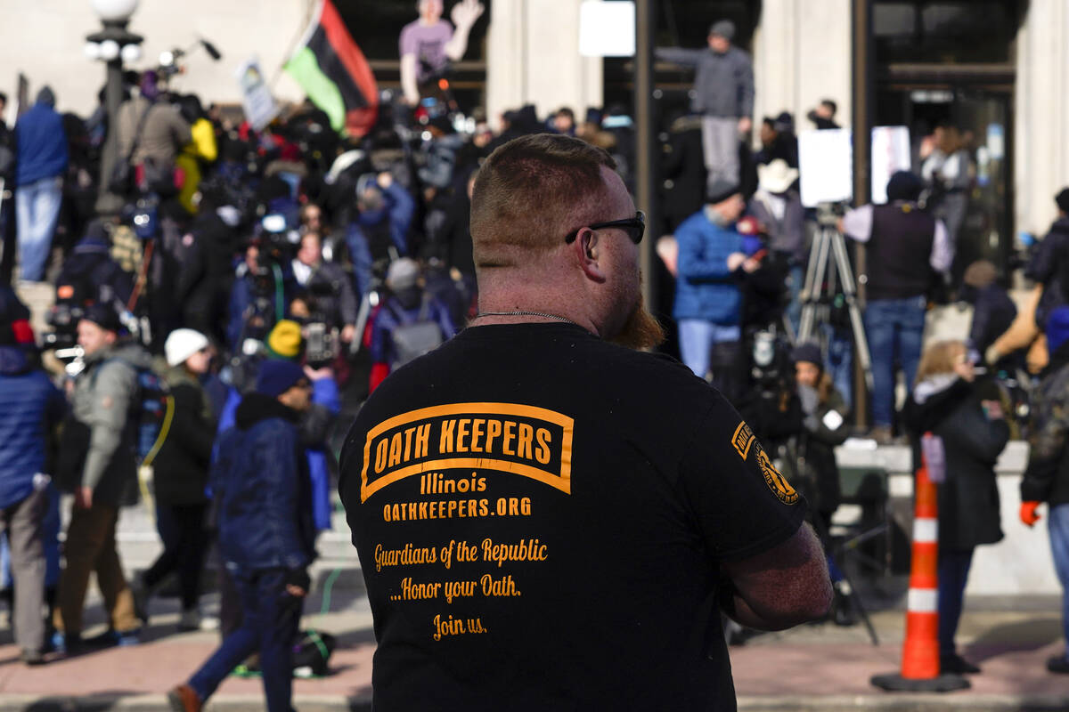 FILE - A man wearing an Oath Keepers shirt stands outside the Kenosha County Courthouse, Nov. 1 ...