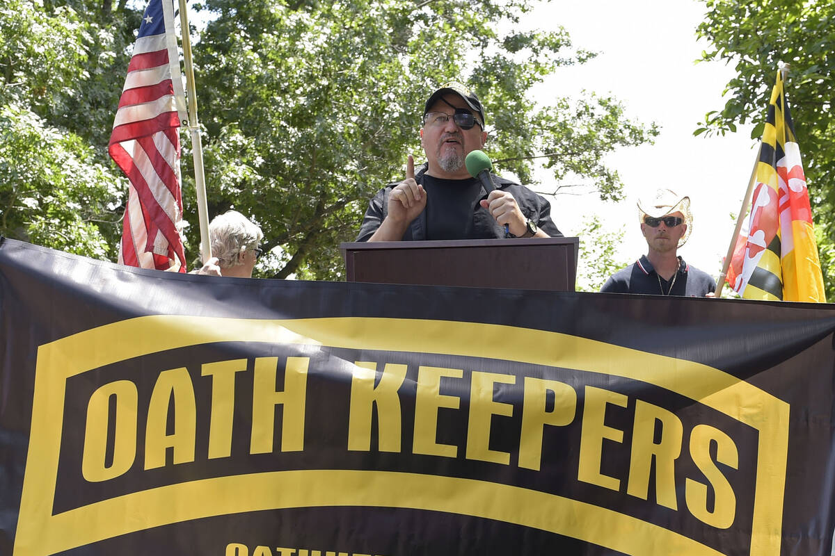 FILE - Stewart Rhodes, founder of the Oath Keepers, center, speaks during a rally outside the W ...