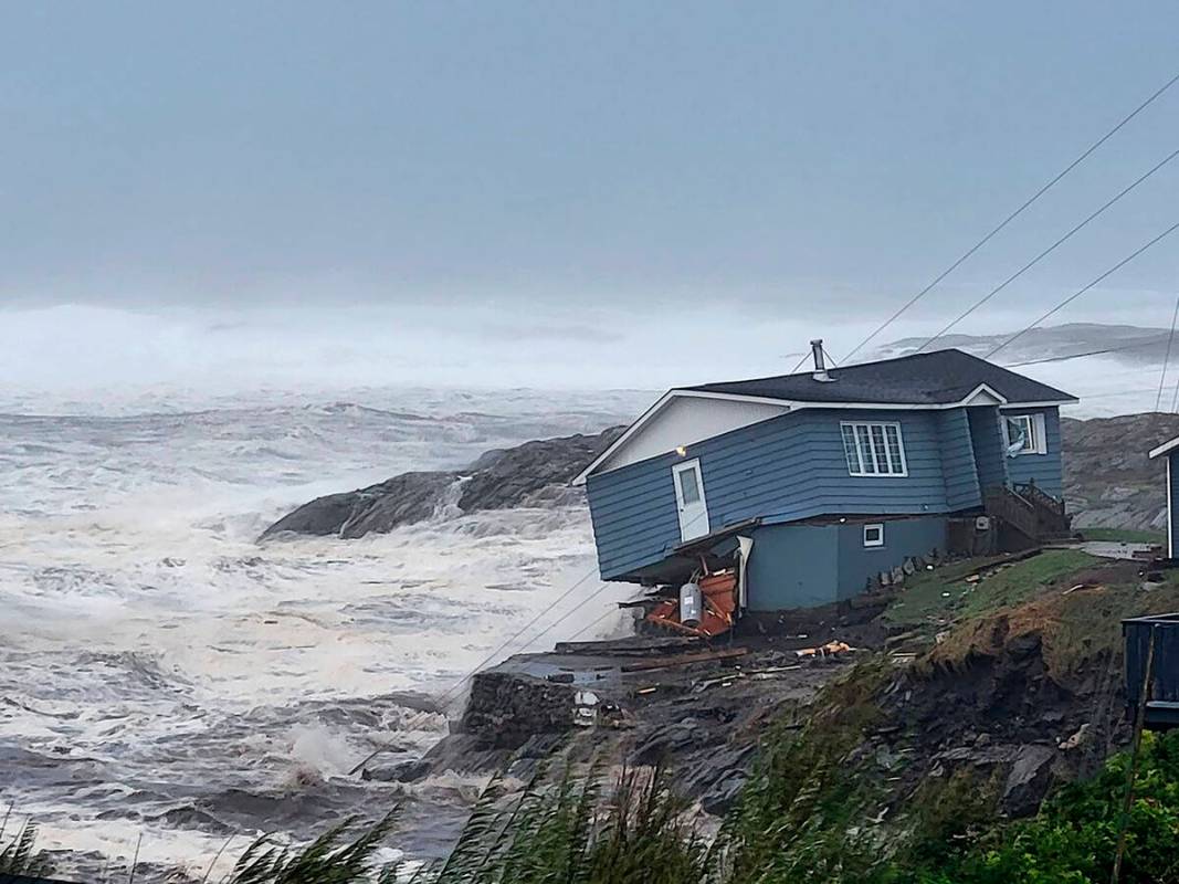 In this photo provided by Wreckhouse Press a home fights against high winds caused by post Trop ...