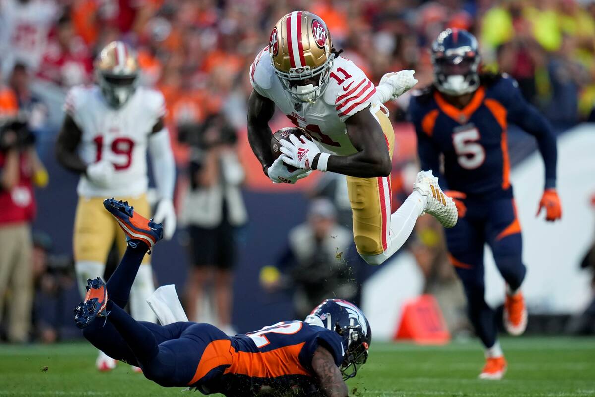 San Francisco 49ers wide receiver Brandon Aiyuk (11) is tackled by Denver Broncos safety Kareem ...