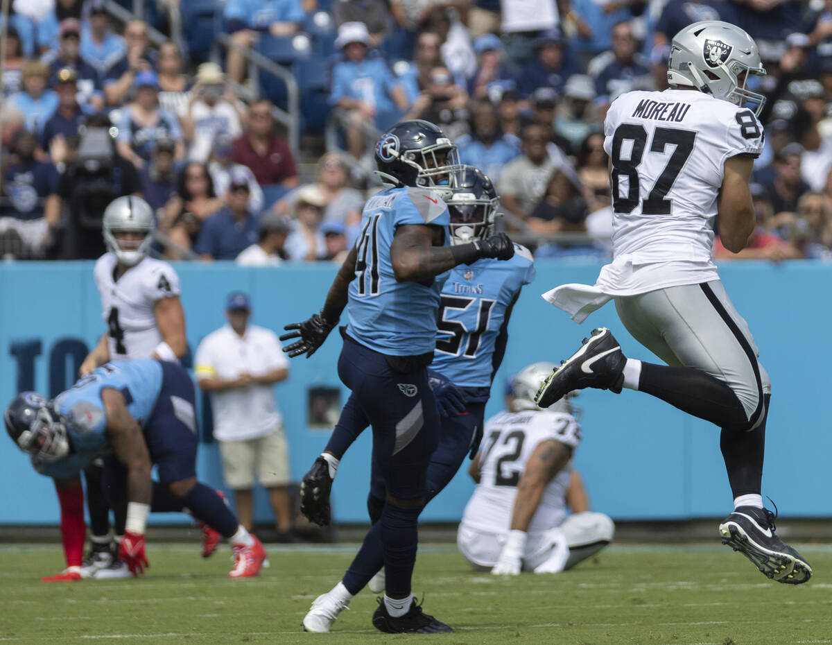 Raiders tight end Foster Moreau (87) makes a leaping catch past Tennessee Titans linebacker Zac ...