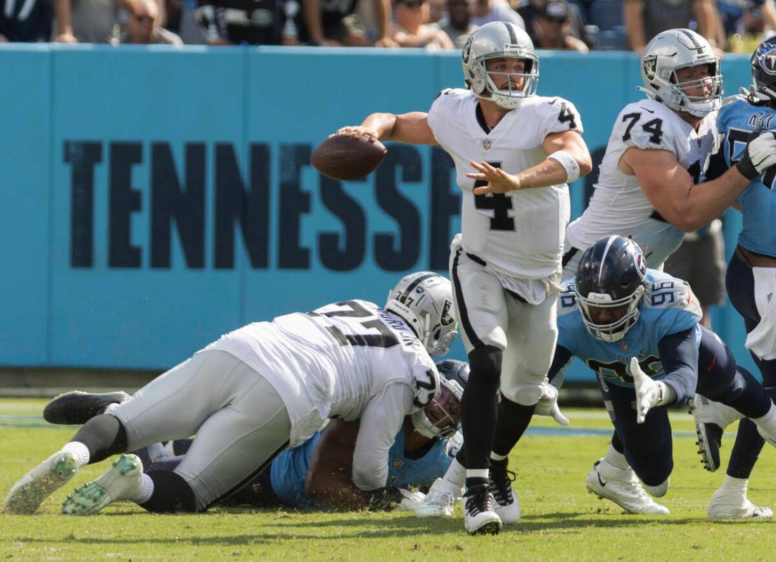 Raiders quarterback Derek Carr (4) gets a pass away under pressure from Tennessee Titans defens ...